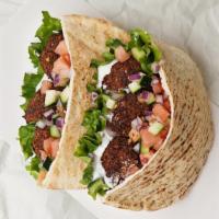 Falafel Pita Sandwich · Vegan falafel balls on a pita with lettuce, tomato, onion, and your choice of sauce.