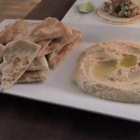 Hummus · Chickpea, sesame paste, virgin olive oil served with warm pita triangles.