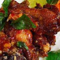 Spicy Wings · Crispy chicken wings, sauteed with chili, garlic, and topped with crispy sweet basil.