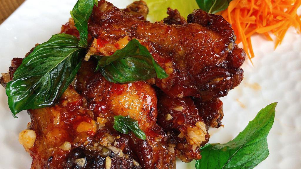 Spicy Wings · Crispy chicken wings, sauteed with chili, garlic, and topped with crispy sweet basil.