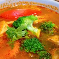 Tom Yum · Hot and sour soup with mushrooms, tomatoes, lemongrass, galanga from the ginger family, and ...