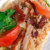 Roast Duck Fried Rice · Fried rice with boneless roast duck slices, egg, tomatoes, crab paste, and onions. Topped wi...