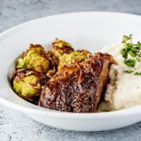 Short Ribs (Gf) · Red wine braised short rib with garlic mashed potatoes and brussel sprouts.