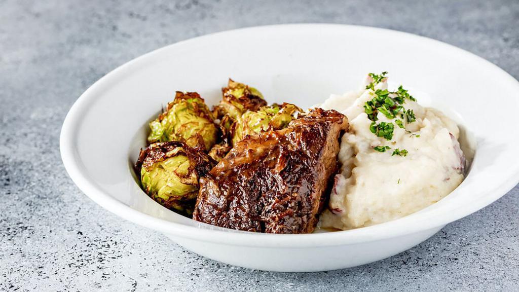 Short Ribs (Gf) · Red wine braised short rib with garlic mashed potatoes and brussel sprouts.