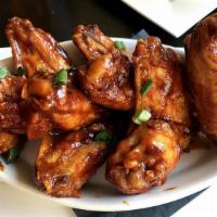 Warrior Wings · Fried chicken wings tossed in our sweet chili sauce.