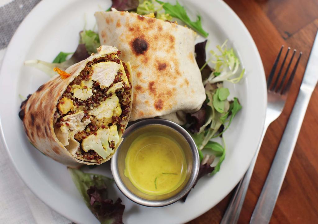 Vegan Chicken Curry Wrap · Roasted cauliflower and chickpeas, red quinoa, caramelized onions, yellow coconut curry sauce, choice of flour or wheat tortilla.