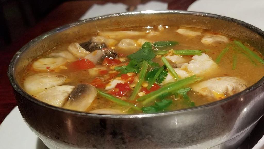 Tom Yum (Chicken) · sour soup with mushrooms, lemongrass, galangal, lime juice, chili paste, kaffir leaves, and cilantro.