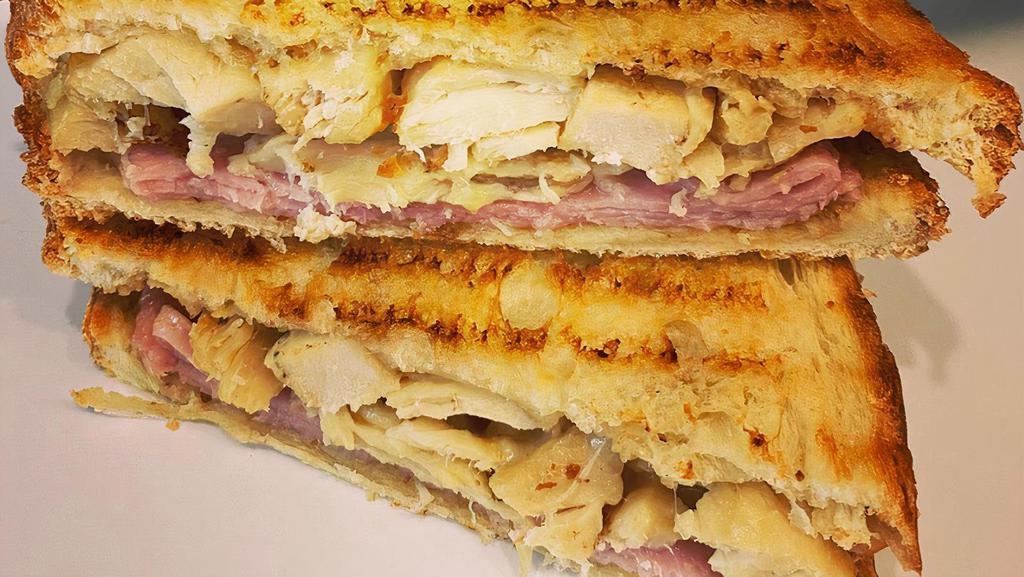 Grilled Chicken Breast Panini · Lettuce, tomatoes, red onions, mayo, mustard, pesto, olive oil, grilled chicken, and cheddar cheese and mozzarella cheese.