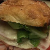 Smoked Turkey Panini · Lettuce, tomatoes, red onions, mayo, mustard, pesto, provolone cheese, olive oil, and mozzar...