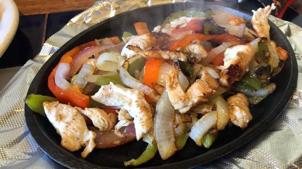 Sizzling Fajitas x1 · Fajita-marinated steak, chicken, prawns, or a combo, served sizzling with onions and bell peppers. Comes with arroz, frijoles, guacamole, pico de gallo, and choice of tortillas.