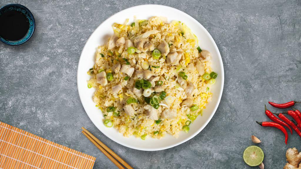 Cluckin' Fried Rice · Pan seared chickens, eggs, peas, and carrots over a bed of rice.