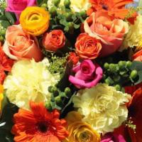 SK006. Brighten Your Day · Orange gerbera, yellow ranunculus, hot pink roses, peach roses, green berries, yellow carnat...