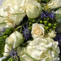 SK008. Forever · White hydrangea, blue thistle, white roses, green berries.