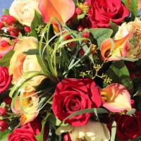SK005. Way to My Heart · Red roses, orange mini Callas, peach ranunculus, red berries, bear grass.