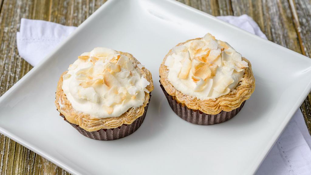 Set of 2 Coconut Cream Pie · Salted caramel & coconut pastry cream in an all-butter flaky crust, topped with lightly-sweetened whipped cream and toasted coconut flakes.