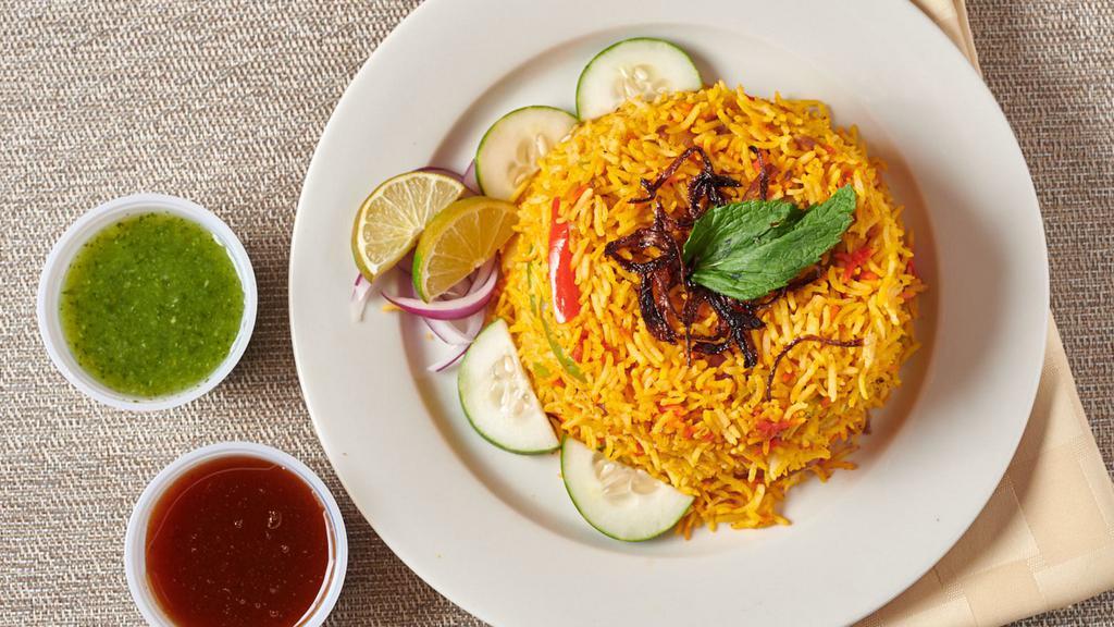Chicken Biryani · Basmati Rice Cooked With Chicken And Spices.