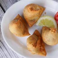 Samosa (2) · Veggie turnover, stuffed with potatoes, green peas, herbs and spices, served with chutney