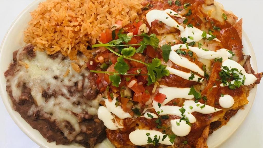 Chorizo Chilaquiles · Three eggs scrambled with chorizo, corn tortilla chips and ranchero sauce topped with jack cheese. Served with rice, pinto beans, pico de gallo and sour cream.