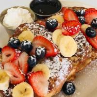 Berry French Toast · Three slices of French toast topped with strawberries, blueberries and bananas. Served with ...