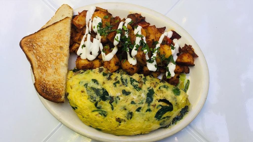 Chicken Omelet · Three egg omelet with grilled chicken, mushrooms, spinach, pesto and jack cheese. Served with breakfast potatoes and toast.