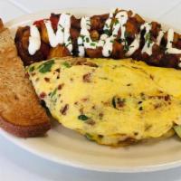 California Omelet · Bacon, caramelized onions, spinach, avocado and jack cheese. Served with breakfast potatoes ...