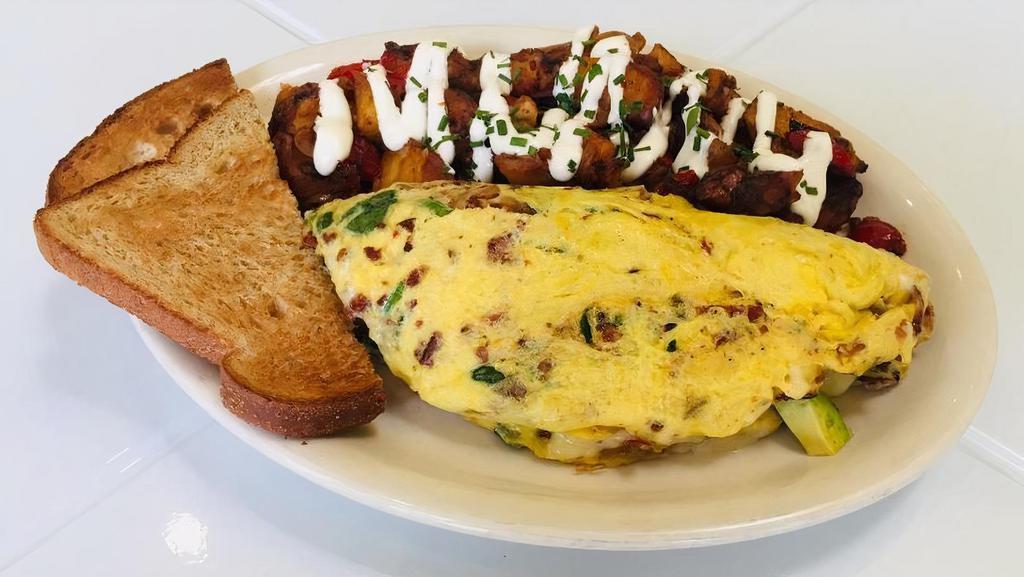 California Omelet · Bacon, caramelized onions, spinach, avocado and jack cheese. Served with breakfast potatoes with sour cream and your choice of toast.