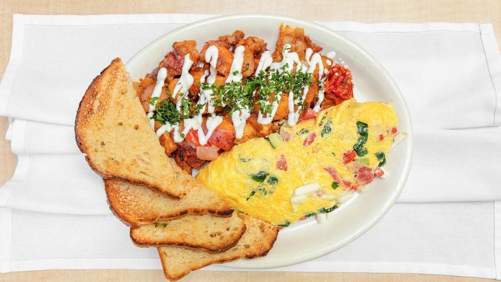 Farmer's Omelet · Zucchini, roasted red peppers, spinach and feta cheese. Served with breakfast potatoes with sour cream and your choice of toast.