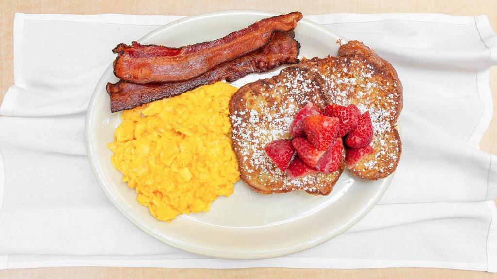 French Toast Combo · Two cinnamon challah french toast, two eggs any style and choice of bacon, chicken apple sausage or hot link.