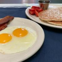 Pancake Combo · Two buttermilk pancakes, two eggs any style and choice of bacon, chicken apple sausage or ho...