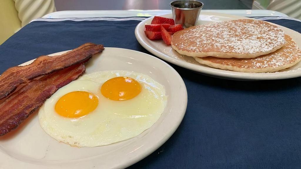 Pancake Combo · Two buttermilk pancakes, two eggs any style and choice of bacon, chicken apple sausage or hot link.