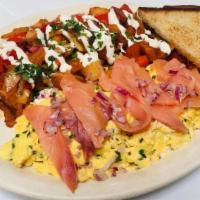 New York Scramble · Eggs scrambled with sour cream and chives, topped with smoked salmon and diced red onion ser...