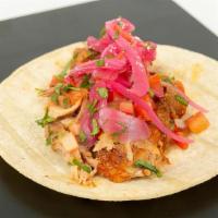Cochinita  Pibil Taco · Traditional Yucatan style pork, pickled onions, salsa verde, micro cilantro