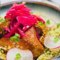 Cochinita Pibil · Achiote marinated pork cooked in banana leaves served with cilantro rice, refried black bean...
