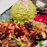 Pollo Pibil · Juicy marinated chicken with achiote, sour orange juice, and spices, and topped cranberry- h...