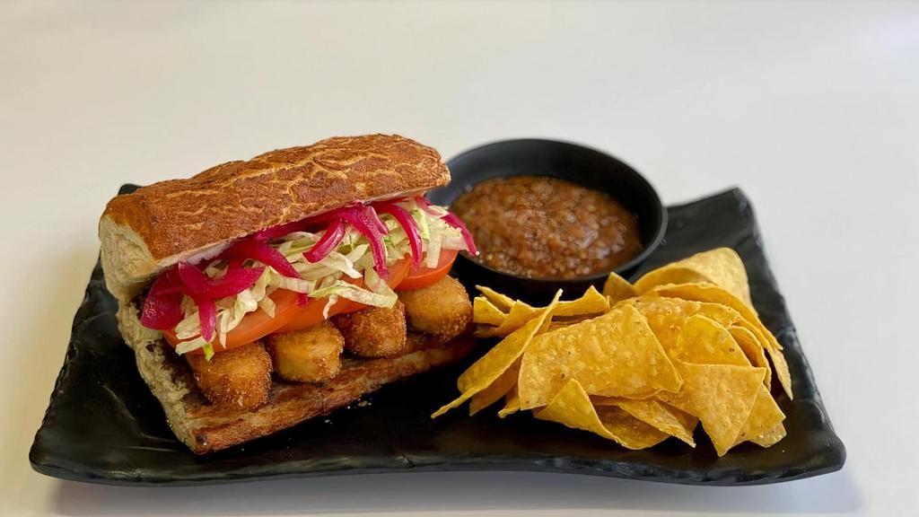 Torta  De Vegan Fried Chicken · Vegan Fried Chicken Refried Black beans, Vegan Mayonnaise, shredded lettuce, sliced tomatoes, pickled red onions. Freshly made-to-order chips served with homemade roasted tomatoes salsa.