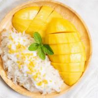 Mango Sticky Rice · Traditional dessert of sweet sticky rice with a side of ripe mango slices.