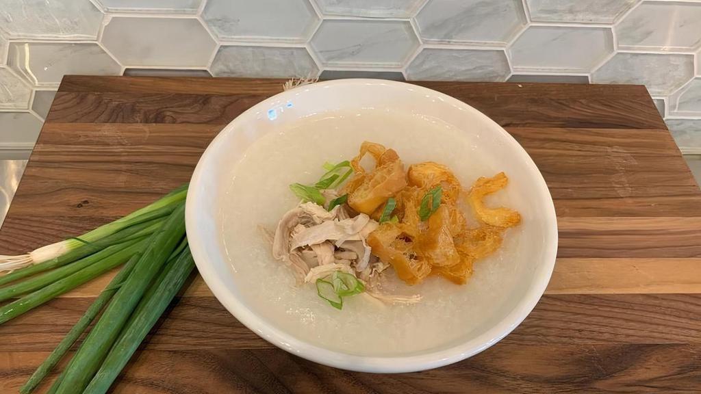 Chicken Congee. · Homemade Rice Porridge simmered in chicken broth with green onions, served with a Chinese Donut