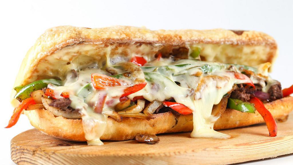 Philly Cheesesteak Sandwich with Mushrooms & Peppers · Philly Cheesesteak sandwich made with steak strips, cheese, onions, mushrooms, and peppers.
