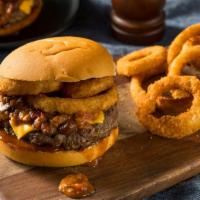 Onion Ring Cheeseburger · Mouthwatering burger topped with melted cheese, onion rings, lettuce, pickles, onions, tomat...