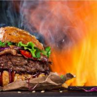 The MONSTER Burger · Mouthwatering burger topped with bacon, fried egg, lettuce, tomatoes, onions, pickles, chedd...