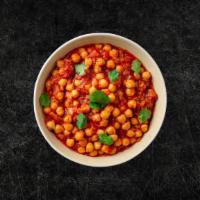 Chickpea Masala (Vegan) · Whole chickpeas, slow cooked till soft in an onion and tomato curry with Indian whole spices...