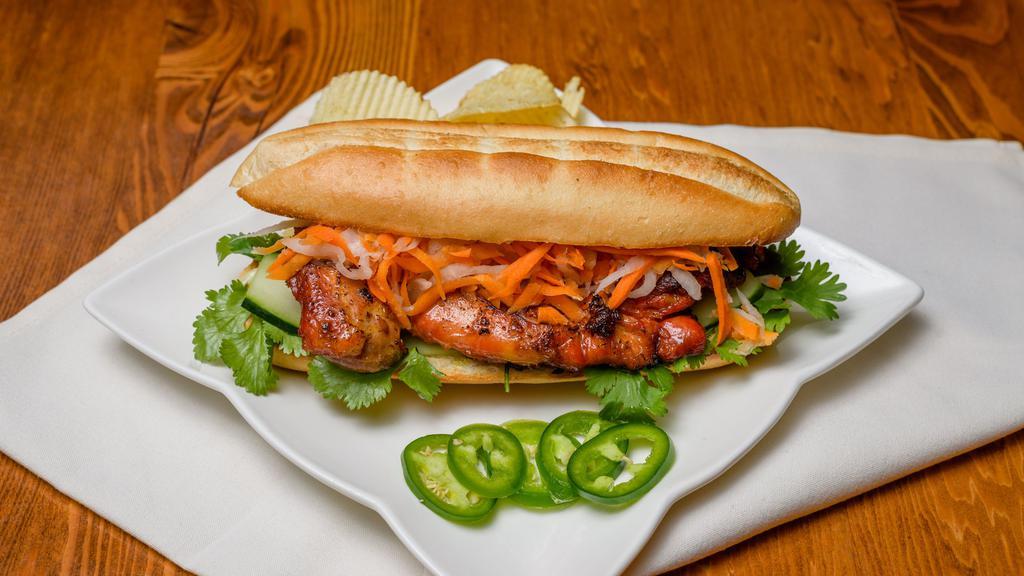 Vietnamese Grilled Chicken Bánh Mì · Vietnamese sandwich with grilled chicken, pickled vegetables, cilantro, and Vietnamese mayo. served with a side of potato chips.
