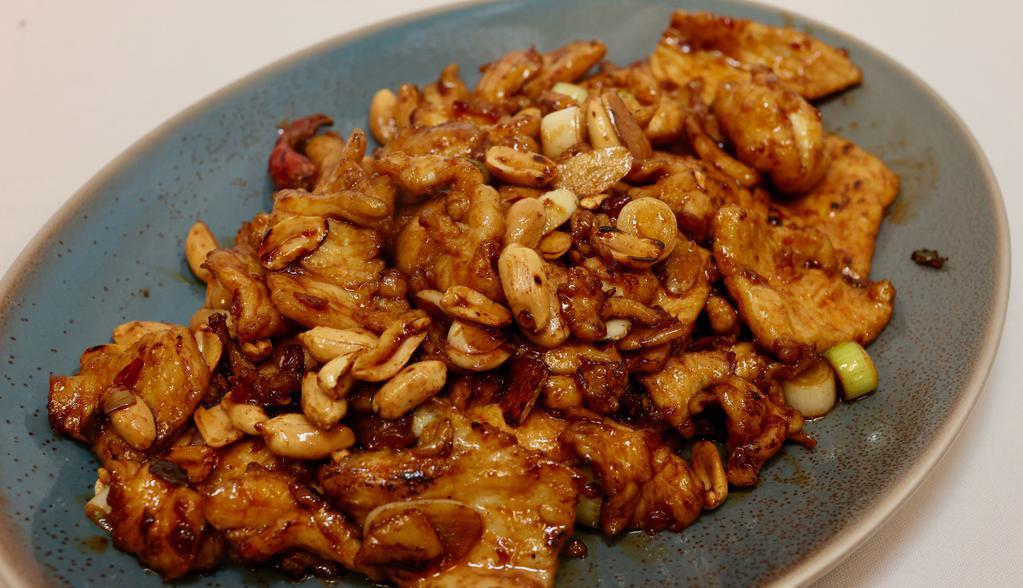 Authentic Kung Pao Chicken · Spicy. Sliced chicken breast stir-fried with fresh peanuts, dried red chili peppers, ginger, and garlic in an authentic fresh-made chili pepper sauce.