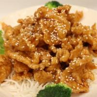 Sesame Crispy Chicken · Slices of chicken quick fried and topped with sesame seeds in a tangy sauce.