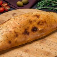 Go Green Calzone · Pan-baked thick pizza crust layered with fresh pesto sauce, spinach, diced tomatoes, garlic,...