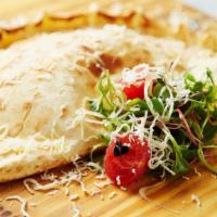 Veggie Calzone · Pan-baked thick pizza crust layered with chopped mushrooms, bell peppers, diced tomatoes, on...