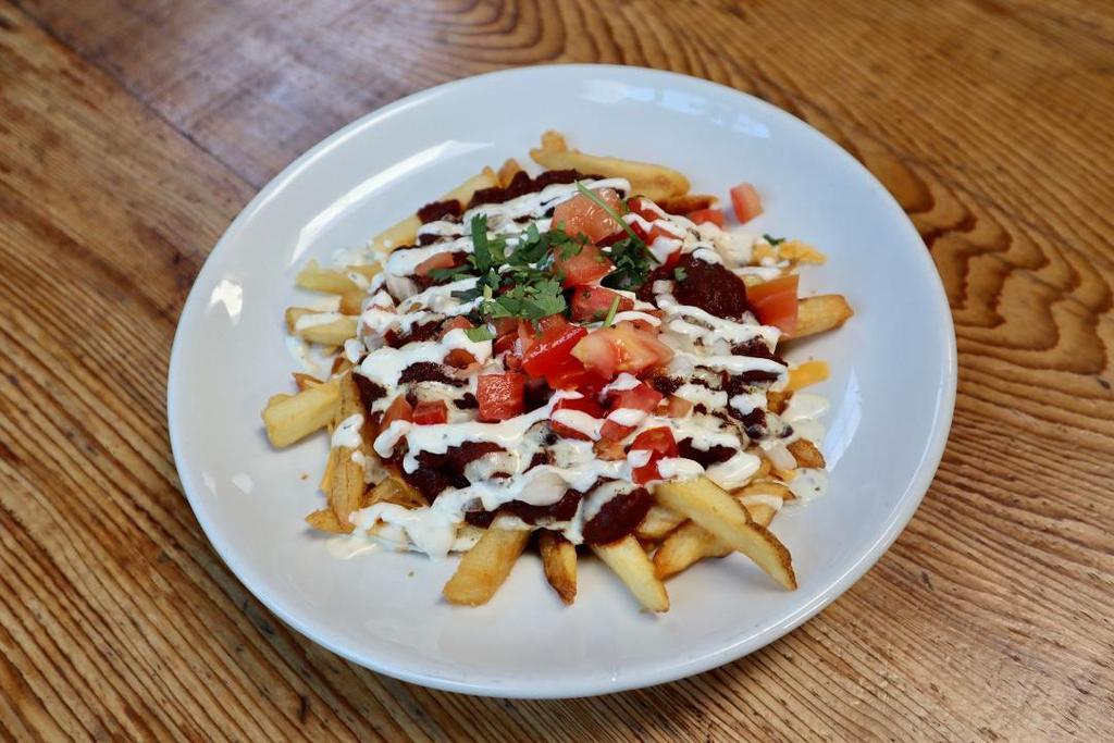 CHILI FRIES · fries, veggie chili, cheddar, lime crema, diced onion, tomato, cilantro. (fries fried in fryer with gluten products)