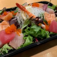 Sashimi Salad · Assorted sashimi, tobiko,  topped on mixed greens, house dressing