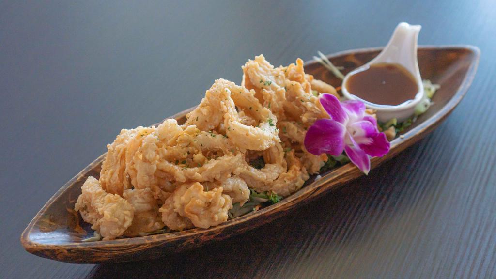 Crispy Calamari · Fried marinated calamari served with sweet and sour pineapple sauce.