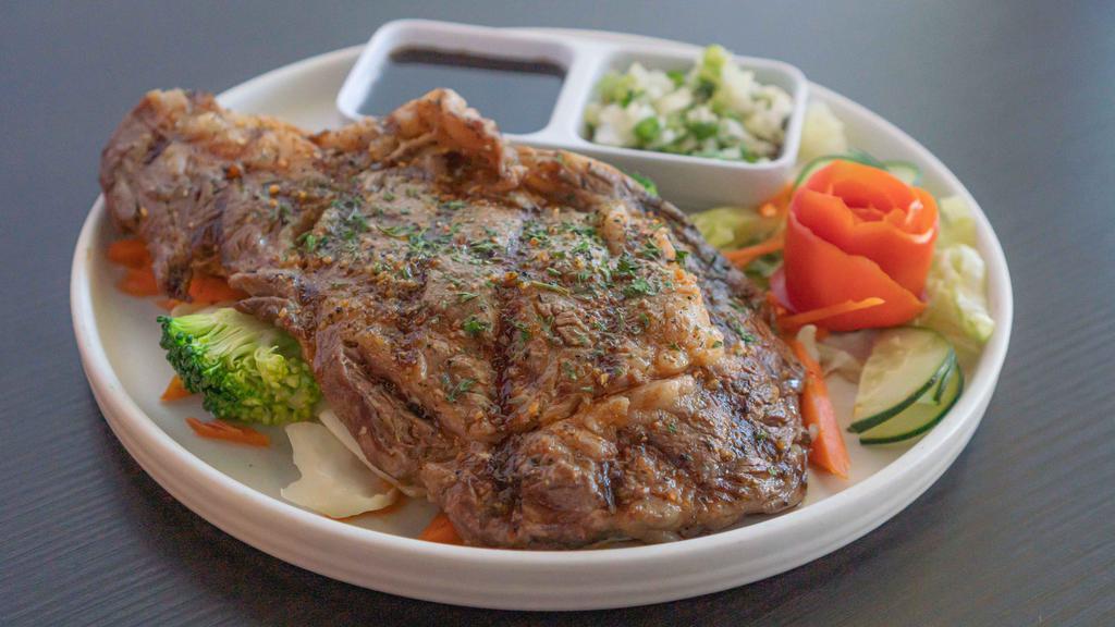 Rib Eye Steak · Grilled rib eye steak; served with homemade teriyaki sauce, onion sauce, and sautéed mixed vegetables.